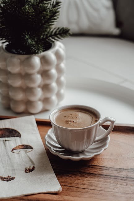 A cozy scene featuring a cup of coffee beside a decorative potted plant, ideal for relaxing indoors.